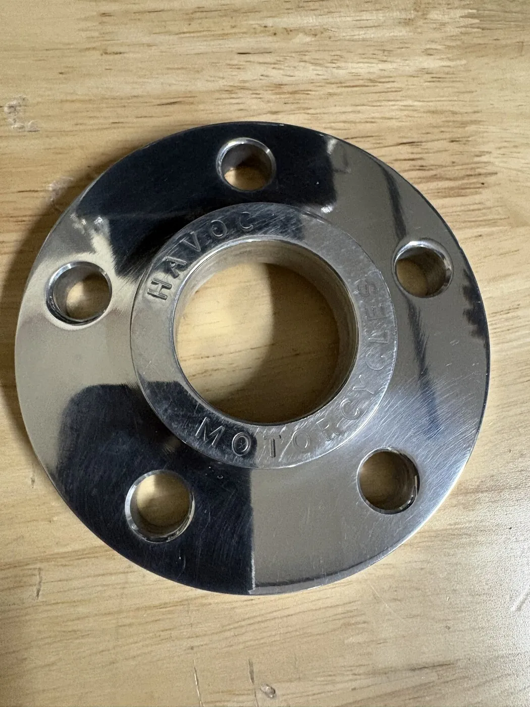 A Havoc rotor spacer. It fits between the hub and the rotor to move the rotor outward by a precise amount, with a raised center register that locates the rotor concentric with the hub.