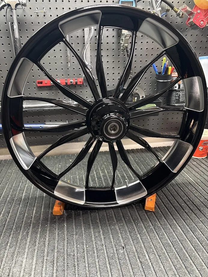 A Havoc Special 21 x 3.5 front wheel in gloss black with machined accents: the largest front that fits a Touring model using stock trees – bigger wheels require more rake.