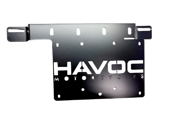 Road-Lock saddlebag amplifier bracket in black powder coat with the laser-cut Havoc Motorcycles logo, mounting slots and cable-management openings, on a white background