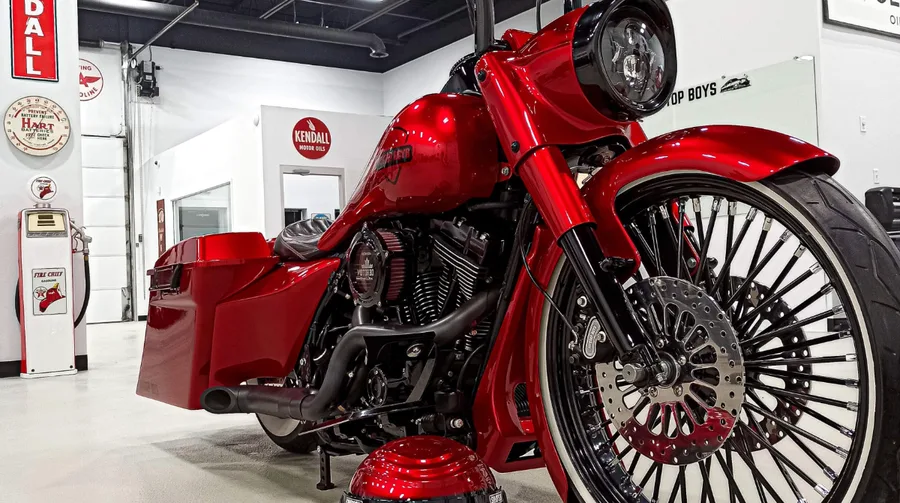 Candy red custom Harley-Davidson bagger with a 23-inch Havoc King Spoke front wheel