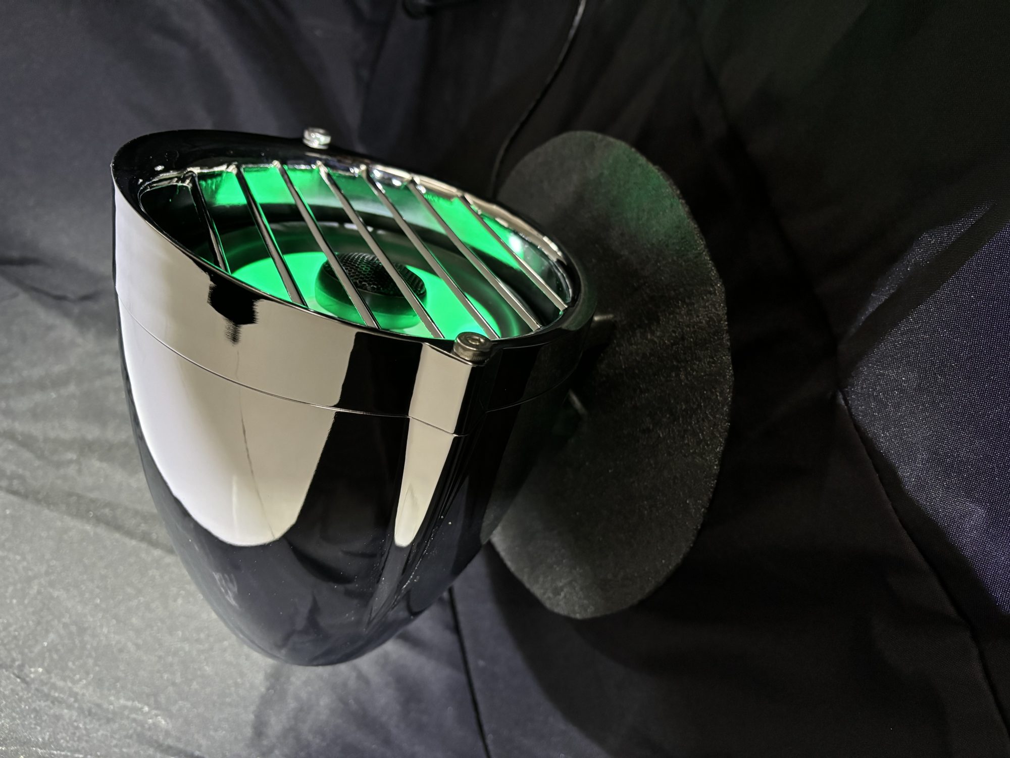 Havoc Roar Stereo highway bar pods glowing green with RGB illumination on a Road King