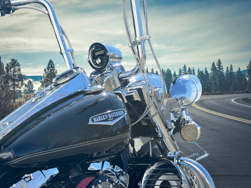 Side view of Harley-Davidson Road King showing Aquatic AV GP1 gauge stereo in billet nacelle pod and 6.5 inch billet highway bar speaker pod on the crash bar