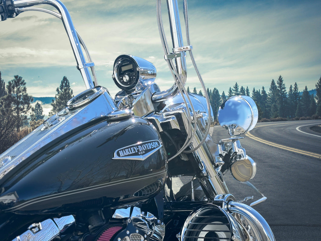 Side view of Harley-Davidson Road King showing Aquatic AV GP1 gauge stereo in billet nacelle pod and 6.5 inch billet highway bar speaker pod on the crash bar